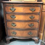 A reproduction George III style mahogany cross-banded serpentine front bachelor's chest, the moulded