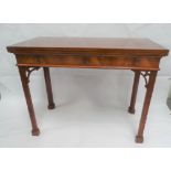 A reproduction George III Chippendale style tea table, the hinged swivel top over four blind fret