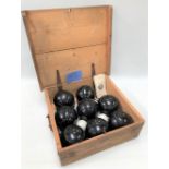 A set of eight early 20th century Harrods lawn bowls in ebony and with ivory dots, stamped Harrods