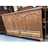 19th Century pine mule chest, the hinged top over three fielded panels and two drawers upon