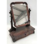 Mahogany swing toilet mirror with carved supports over a base with a single drawer and on leaf