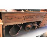 A late Georgian mahogany dresser base, the moulded top over three frieze drawers and a shaped