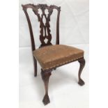 An early 20th century George III mahogany dining chair, with foliate scroll carved top rail over a