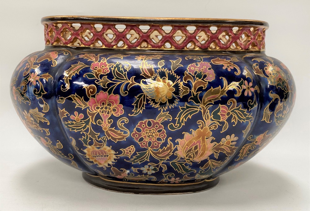 A Zsolnay Pecs oval lobed jardinière with pierced rim and painted with foliate scrolls with gilded