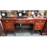 A 19th Century mahogany inlaid bow front sideboard, the central bowed drawer with shell paterae