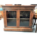 A Victorian burr walnut veneered inlaid low glazed bookcase, with brass mounts, with a pair of