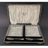 A George VI cut glass pair of butter dishes with silver butter knives, Sheffield 1938, weight of