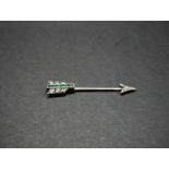 An Art Deco gold diamond and emerald jabot pin in the form of an arrow, the arrow head and
