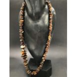 A long raw amber necklace, length overall 86cm approx., weight 105g approx.