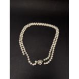 A white gold diamond set double strand pearl necklace, each pearl of 6mm diameter approx., the clasp