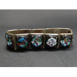 A Persian enamel silver plated bracelet set with enamel panels depicting birds, foliage and river