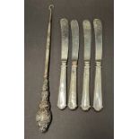 A set of four silver weighted handled fruit knives, together with a silver handled buttonhook (5).