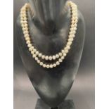 A double strand baroque pearl bead necklace with 9ct. gold clasp, length 47cm.