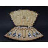 A George V silver set of six teaspoons and sugar tongs within fitted case by W.H. Haseler,