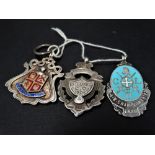 A silver and enamel 'Dulwich Football League' shield fob, together with two other shield fobs.