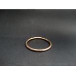 A 9ct. hallmarked gold hollow tube bangle with slightly faceted design, stamped WAXFIELD, maker SRP,