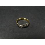 A modern 18ct. hallmarked gold diamond set four stone ring, the diamonds of 0.05ct. spread approx.