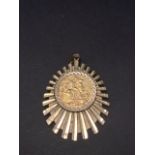 An Edward VII 1909 full sovereign 9ct. hallmarked gold mounted pendant of radial design, length