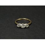 An 18ct. gold and platinum diamond set three stone ring, the central diamond of 0.40ct. spread