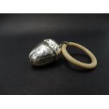 A George V silver child's rattle in the form of an acorn with teething ring, Birmingham 1924, length