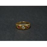 A Victorian 18ct. hallmarked gold diamond and ruby set three stone gypsy ring, the diamond of 0.