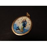 An 18ct. gold mounted (tested) oval pendant set with enamel on metal depiction of St. Maria,