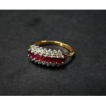 A modern 18ct. gold diamond and ruby twenty two stone half eternity ring, the eight rubies of square