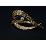 A 9ct. hallmarked gold mid century brooch set with a pearl and with textured finish, London 1966,