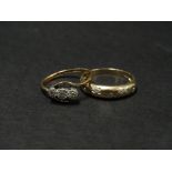 Two 9ct. gold diamond set rings, one gypsy set with five small diamonds, the other a crossover