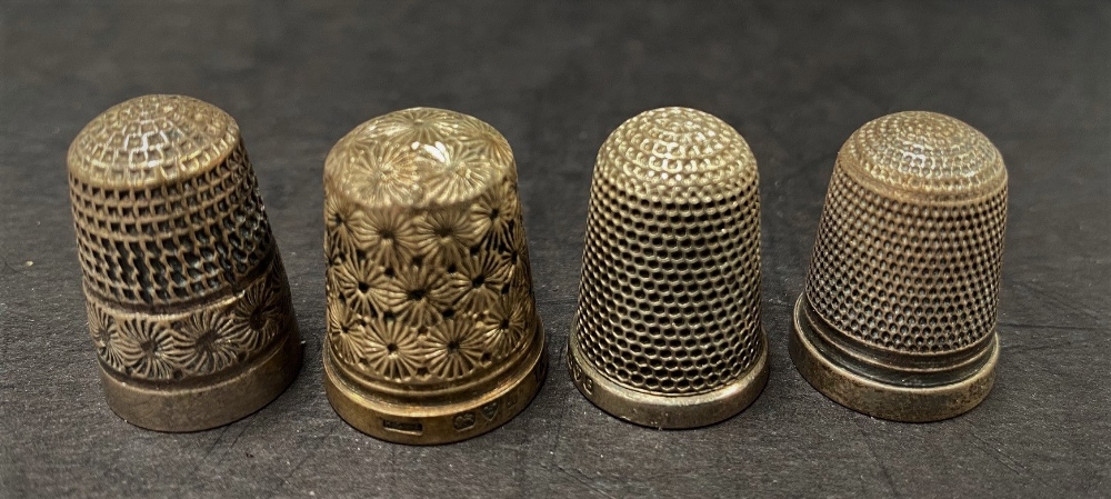 An Edwardian silver thimble by Charles Horner, Chester 1903, together with three other silver