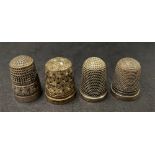 An Edwardian silver thimble by Charles Horner, Chester 1903, together with three other silver