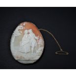 A 9ct. gold mounted oval shell cameo carved with a pair of lovers in a garden, stamped 9ct, 59 x