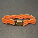 An unusual 19th century coral gatelink bracelet with gold clasp and safety chain, diameter 4.5cm