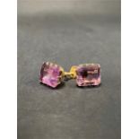A pair of 9ct. gold amethyst set screw back earrings, the emerald cut amethysts measure 7.6 x 4.7mm,