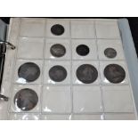 A British coin album containing pre decimal coinage including silver and .500 silver.