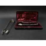 A Victorian silver pair of sugar tongs with bright cut decoration and within fitted case, Chester