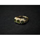 A modern 9ct. hallmarked gold peridot and seed pearl set cluster ring, size 17.5mm diameter approx.,