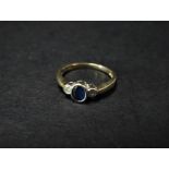A 9ct. hallmarked gold diamond and sapphire three stone ring, the diamonds of 0.05ct spread each