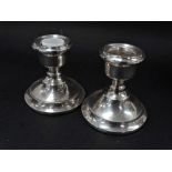 A pair of modern silver squat candlesticks with weighted bases, Birmingham 1965, height 6cm.