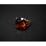 A modern 9ct. gold fire opal set dress ring, the cut stone of cushion shape, measuring 14 x 14mm,