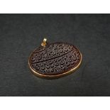 An interesting high purity gold cornelian Islamic pendant with engraved script, 30 x 20mm approx.