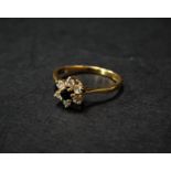 A modern 18ct. hallmarked gold diamond and sapphire set seven stone daisy ring, the diamonds each of