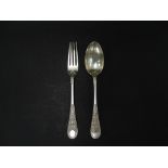 A Victorian silver christening spoon and fork with foliate strapwork decoration to the handle