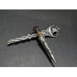 A Scottish silver hardstone and amethyst set dirk brooch, stamped JC&S STERLING, length 6cm,