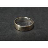 An 18ct. hallmarked white gold band ring, diameter 16.5mm approx., weight 3.1g approx.