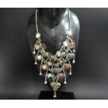 An unusual white metal agate set waterfall necklace, set with twenty three agate cabochons of