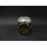 A Victorian silver lidded glass toilet jar, the lid foliate scroll embossed, the glass of yellow