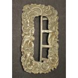 A Victorian silver cast buckle decorated with putti and foliate 'C' scrolls, maker G & M, London