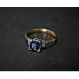 An attractive modern 18ct. hallmarked gold and platinum set three stone diamond and sapphire ring,