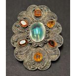 An early 20th century silver abalone shell and citrine set oval lobed buckle with wire and